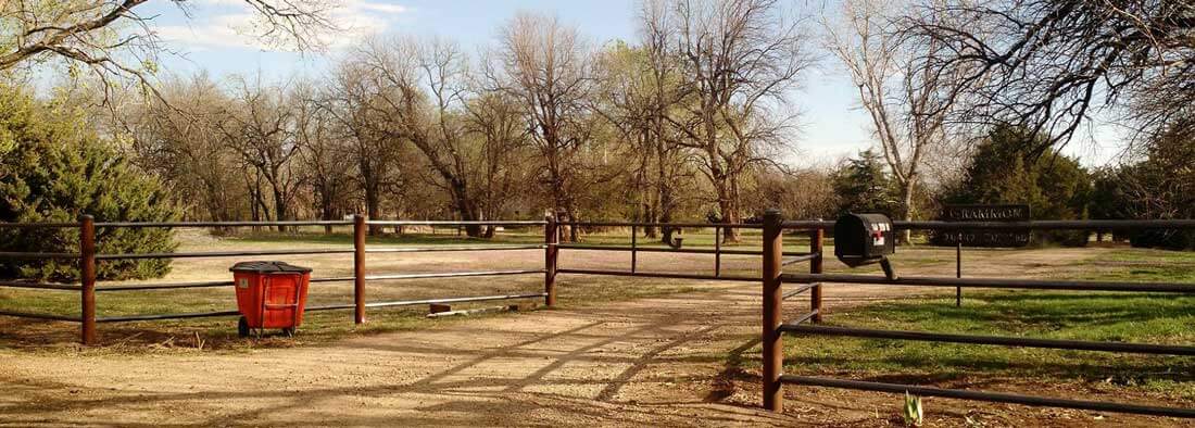 Metal fence and gate, entrance to Prairie Paws